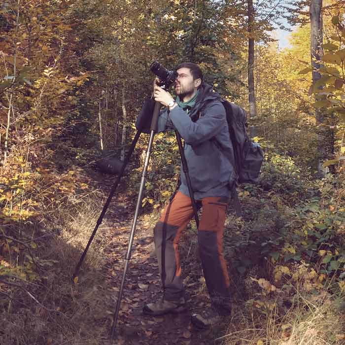 Artem Sapegin is making photos in a forest